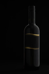 Black wine bottle with blank label isolated on black background