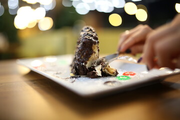 Delicious chocolate cakes on table close up bokehs. a slice of cake 