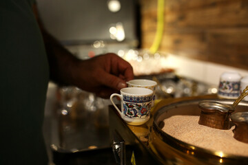 Fototapeta na wymiar turkish coffee cups. Turkish coffee is cooked in the sand.