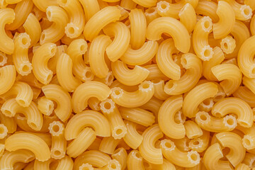 short Italian pipe pasta. Pasta is delicious Italian traditional food made from wheat flour like noodles.Dry pasta background.Top view