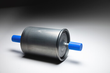 New fuel filter for gasoline internal combustion engine with blue caps on a gray background. New spare parts