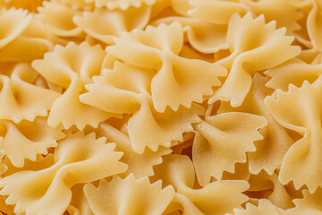 Traditional Italian farfalle pasta. Italian Cuisine. Bow tie noodles. Uncooked dried farfalle. Butterfly. Top view.