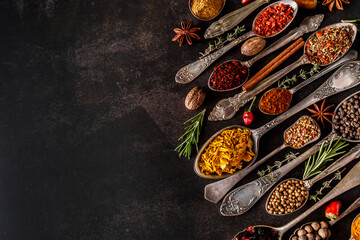 Various spices a vintage spoons on stone table. Colorful Herbal and Spices Oriental marketplace.Top view . Cafe concept. Delicious food delivery.