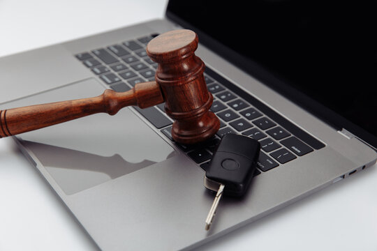 Judge Gavel And Car Keys On Laptop Computer Keyboard. Symbol Of Law, Justice And Online Car Auction