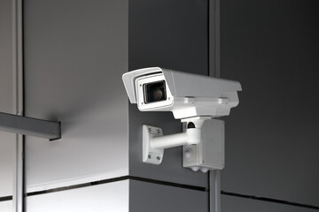 Fototapeta na wymiar Security and video control camera at the wall of building.