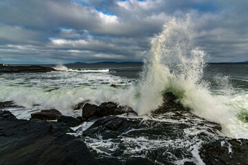 The Atlantic ocean waves crashing in to the cliffs off the west coast of Ireland, County Donegal,  Creavy pier