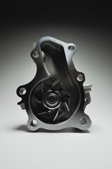 Engine coolant pump. New spare part on a contrasting gradient background for car services