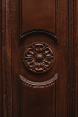 Flower decor on an antique wooden door. Beautiful vintage background.