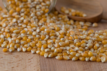 corn for popcorn in front of a glass with focus on foreground
