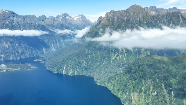 Bird´s eye view over Milford Sound and the surrounding mountains of the Fiordland National Park in New Zealand, South Island. Tourists can visit this area via scenic flights from Queenstown. 