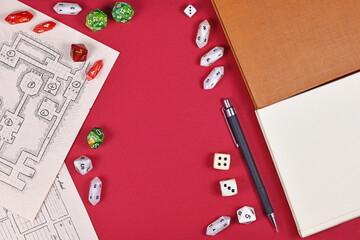 Tabletop role playing flat lay with RPG game dices, hand drawn dungeon map, rule books and pen on...
