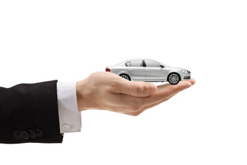 Male hand holding a silver model car