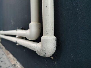 Two water pipes are fixed to the wall. Installation of the pipeline in the house. Renovation in the cottage