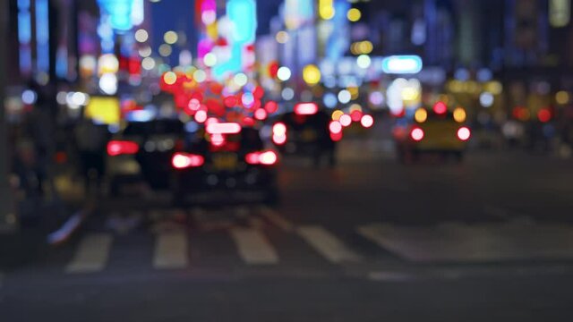 New York City street traffic by night, colorful lights, unrecognizable cars commute