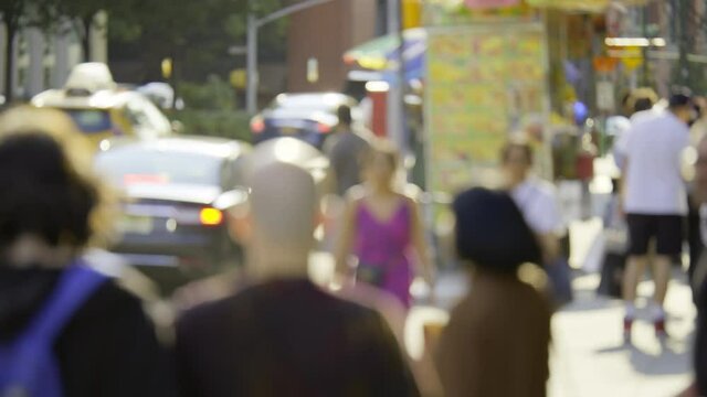 New York City busy street, anonymous people walk and driving cars, sunny cityscape