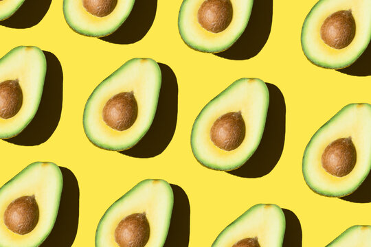 Avocado pattern on the yellow background healthy food green vegetable minimal modern
