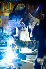 Man welding in a metallurgical workshop