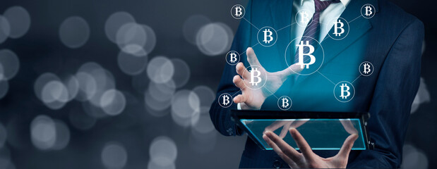 man holding table with bitcoin in screen