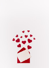 Isolated red paper hearts and envelope with postcard soar over a white background with copy space