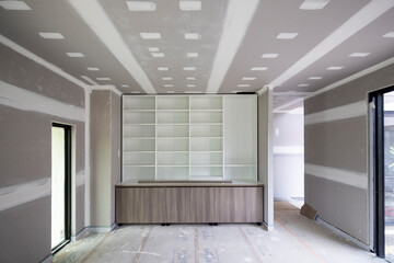 Interior view of an unfinished office and bookcase during a new home build