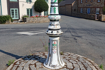 Close up of a decorated lamp post stands on a small traffic island on the edge of the town of...
