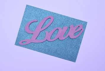 Wooden letters Love on glitter paper. Happy Valentines Day.