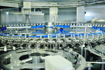 modern equipment for filling beer, carbonated drinks, water in bottles. Industrial production of beverages.