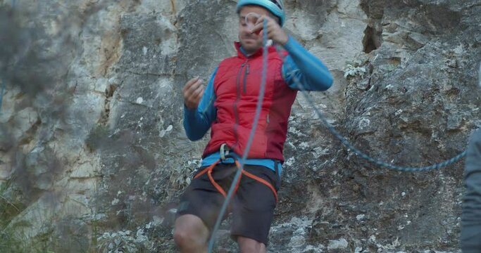 Rock climber putting on his equipment