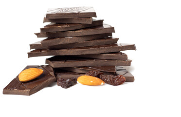 Closeup pieces of dark, inferior chocolate, almonds and raisins on a white background