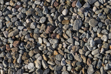 Pile of pebble stones on the beach - background