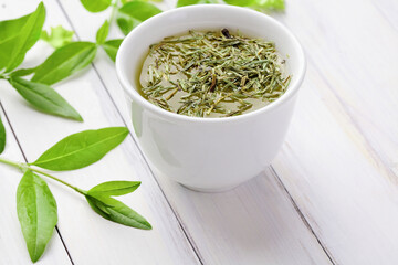 cup of fresh tea, fresh tea leaves. herbal infusion. green tea
