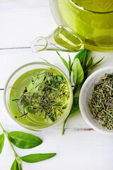 Fototapeta na wymiar cup of fresh tea, fresh tea leaves. herbal infusion. green tea