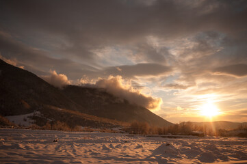 Fototapeta na wymiar Majestic sunset in the winter mountains landscape. Dramatic sky. Azerbaijan nature.