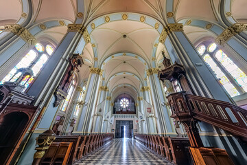 Naklejka premium interior dome and looking up into a old gothic or baroque catholic church ceiling and vaulting and altar