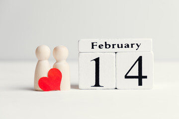 Concept of a couple in love next to the calendar february fourteenth valentine day