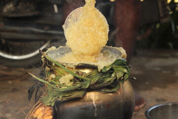 celebrating Traditional Thai Pongal festival to sun god with pot, lamp,wood fire stove, fruits and...
