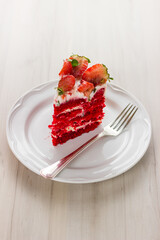 Red velvet cake on white wooden background. with strawberries
