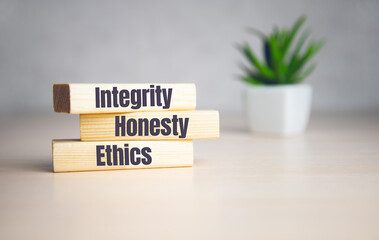 wooden cubes with text INTEGRITY, HONESTY, ETHICS. Diagram and white background.
