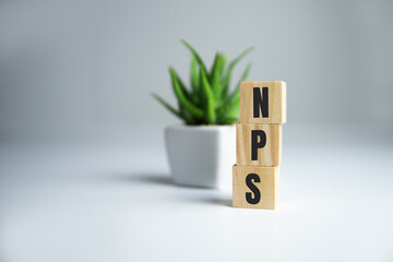 the text NPS NET PROMOTER SCORE on wooden cubes. Business concepts