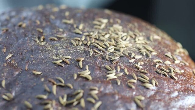 black rye bread sprinkled with caraway seeds close-up