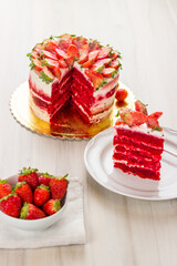 Red velvet cake on white wooden background. with strawberries