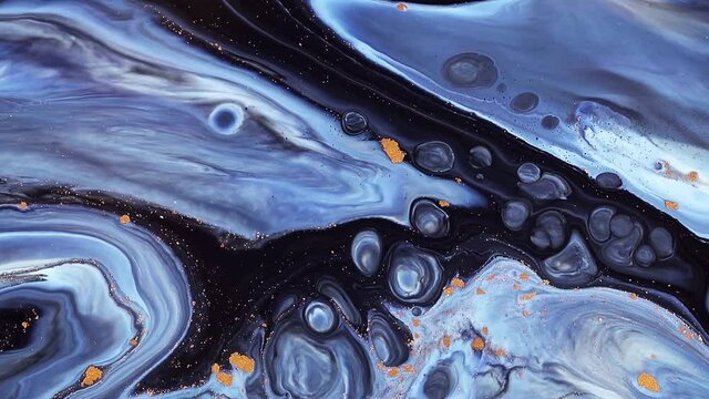 Fluid art painting footage, trendy acryl texture with flowing effect. Liquid paint mixing artwork with splash and swirl. Detailed background motion with blue, golden and navy blue overflowing colors
