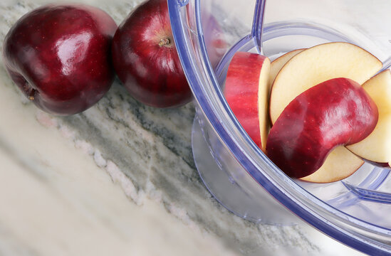 Making Juice With Apple Fruit, Blender Top View. Healthy Eating.