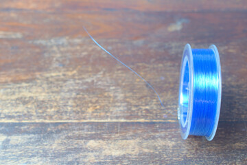 Fishing line on wooden plate