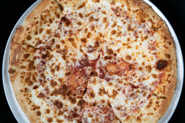 Overhead view of cheese pizza for that plain flavor that many picky eaters prefer.
