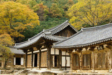 Old wood buildings with tile roofs comprise Hwaeomsa (Hwaeom-sa) Buddhist temple which is photographed here during autumn in Jirisan National Park, South Korea.