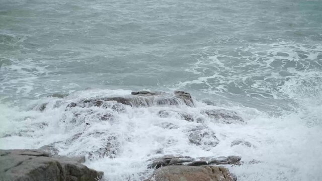 Sea waves crashing on rock.Beautiful wave water splashing at rock on sea shore. 