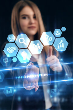 Business, Technology, Internet and network concept. Young businessman working on a virtual screen of the future and sees the inscription: Implementation