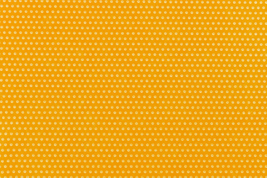 Textile background, yellow with a print in white polka dots.