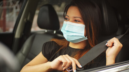young woman with mask driving happy  interior car in the city preventive virus